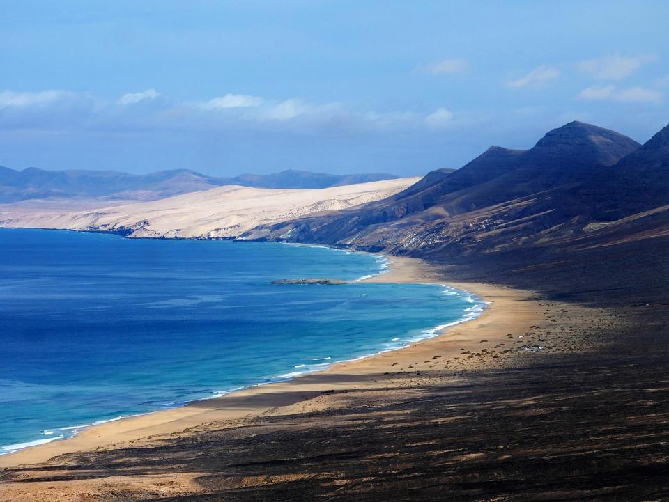 Weiter Sandstrand und Berge auf Fuerteventura